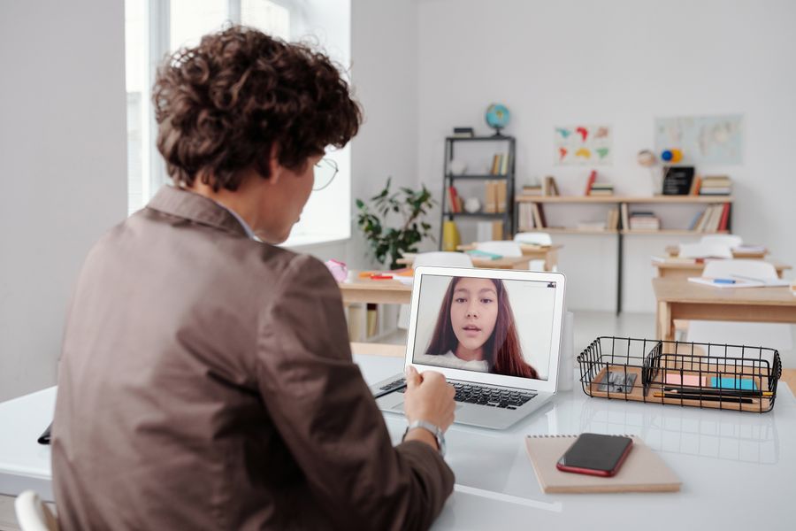 Instructor teaching an online class with a laptop